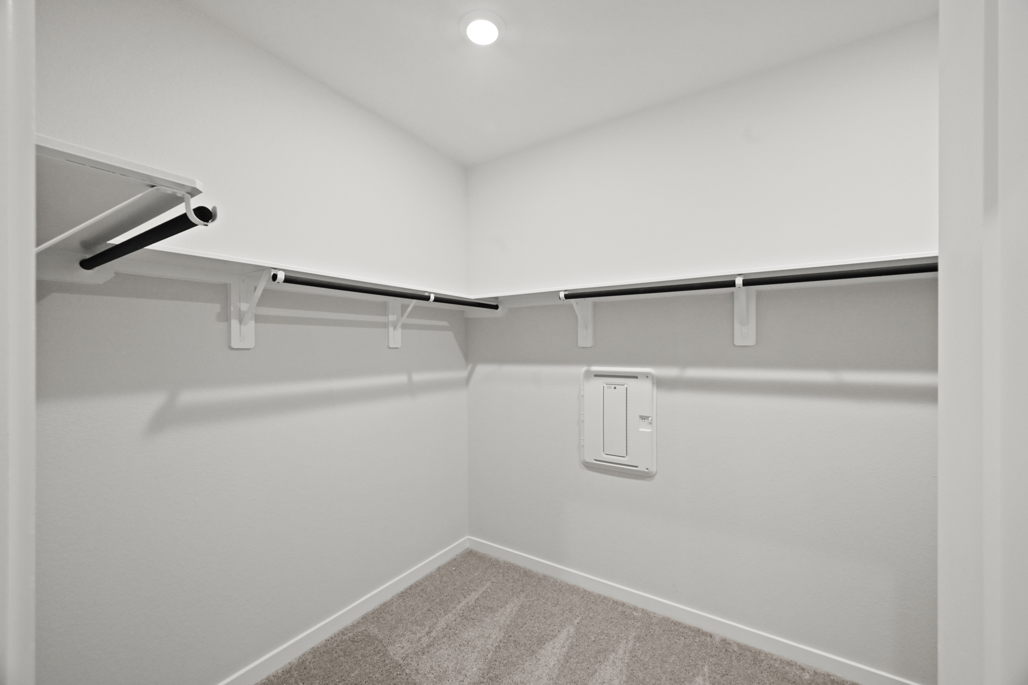 A white wall with a light on it.