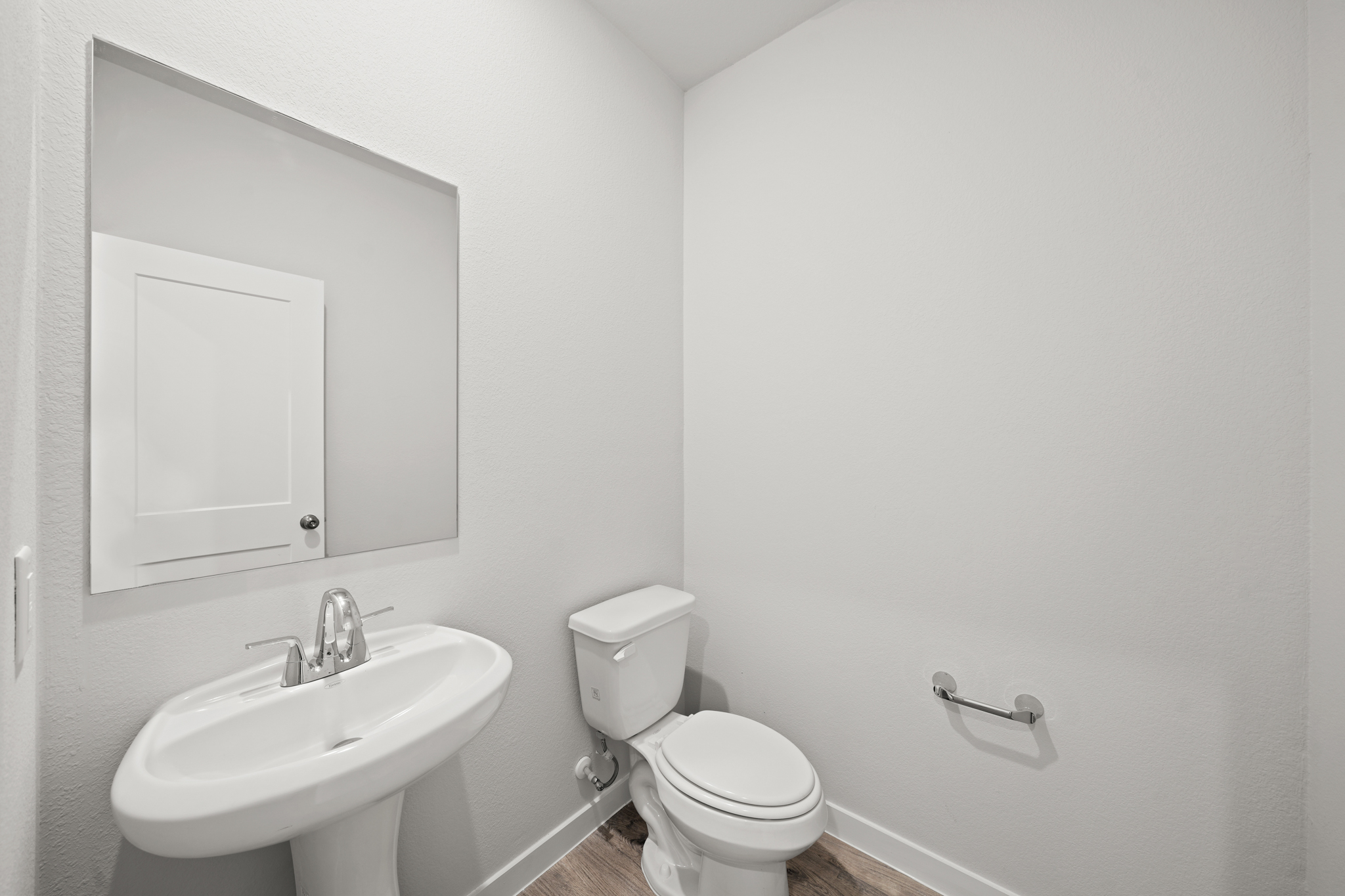 A bathroom with a toilet and sink.