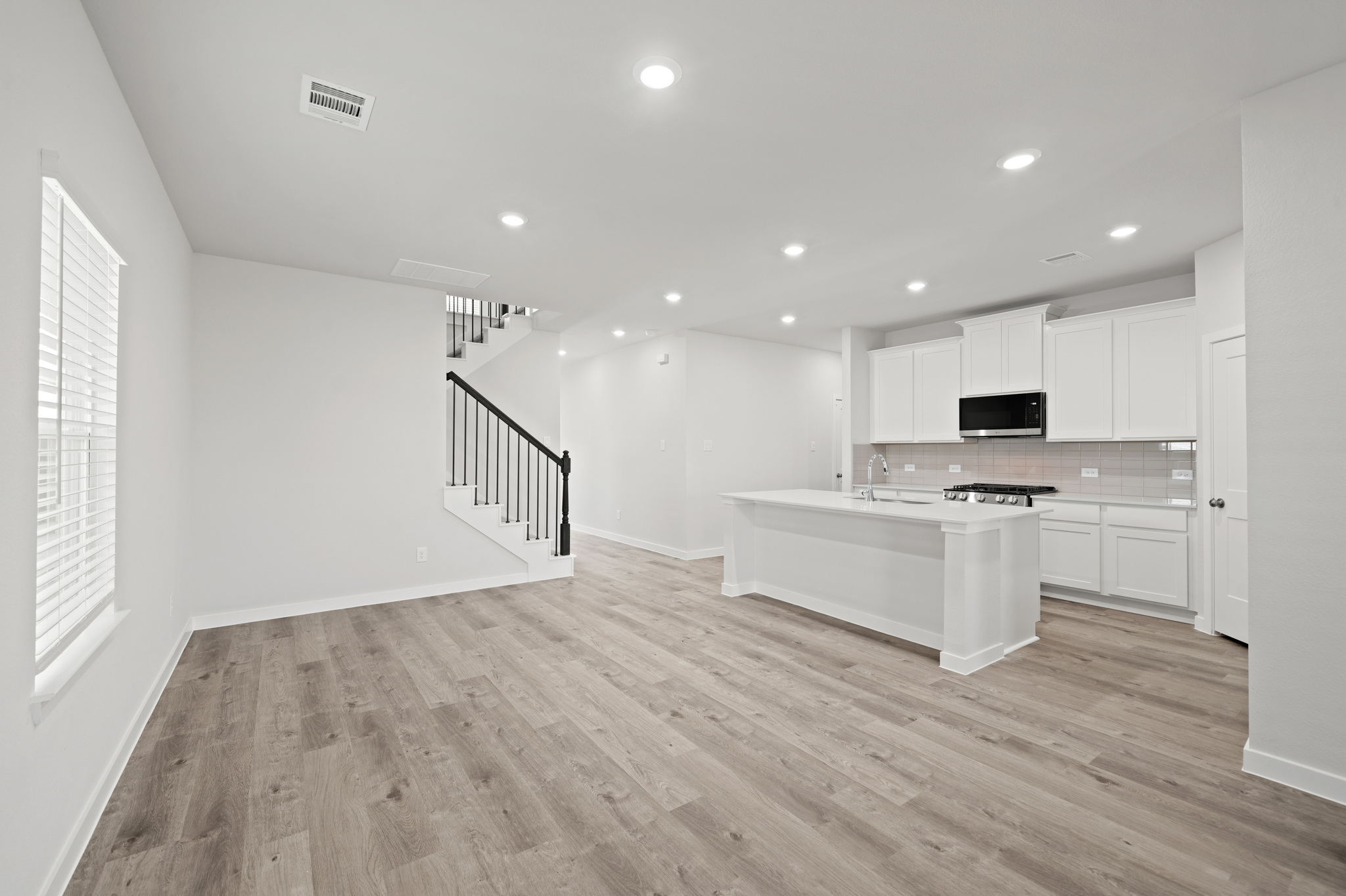 A kitchen with white cabinets.