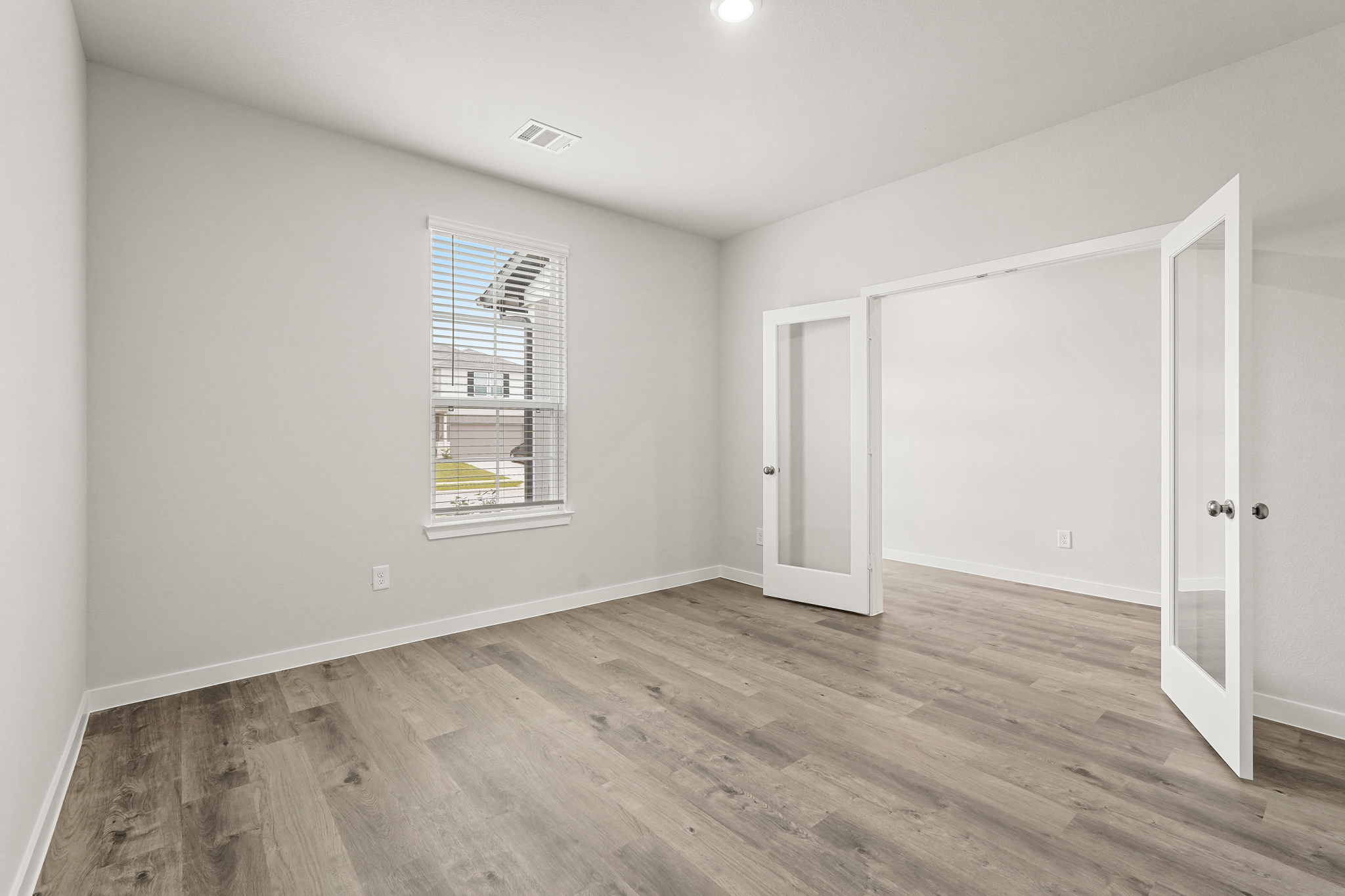 A room with a wood floor and a wood floor.