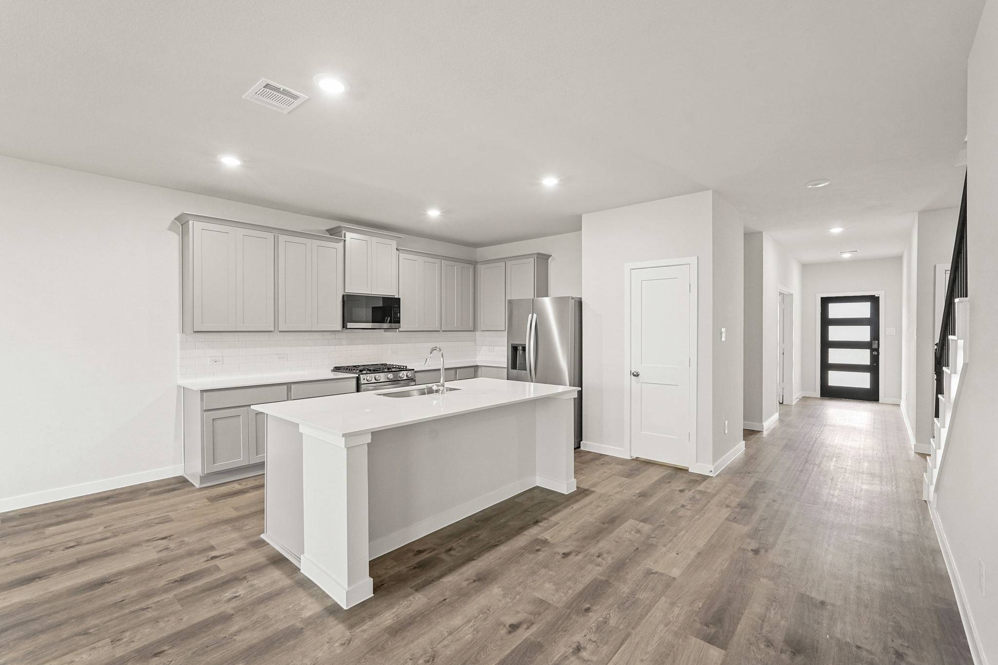 A kitchen with white cabinets.