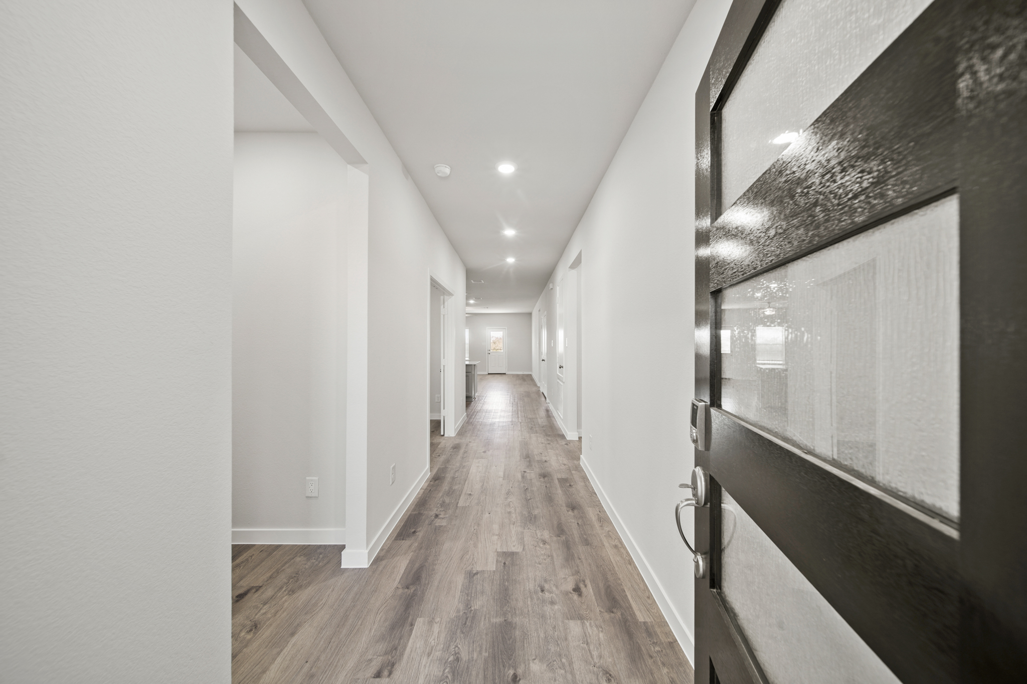 A long hallway with white walls.