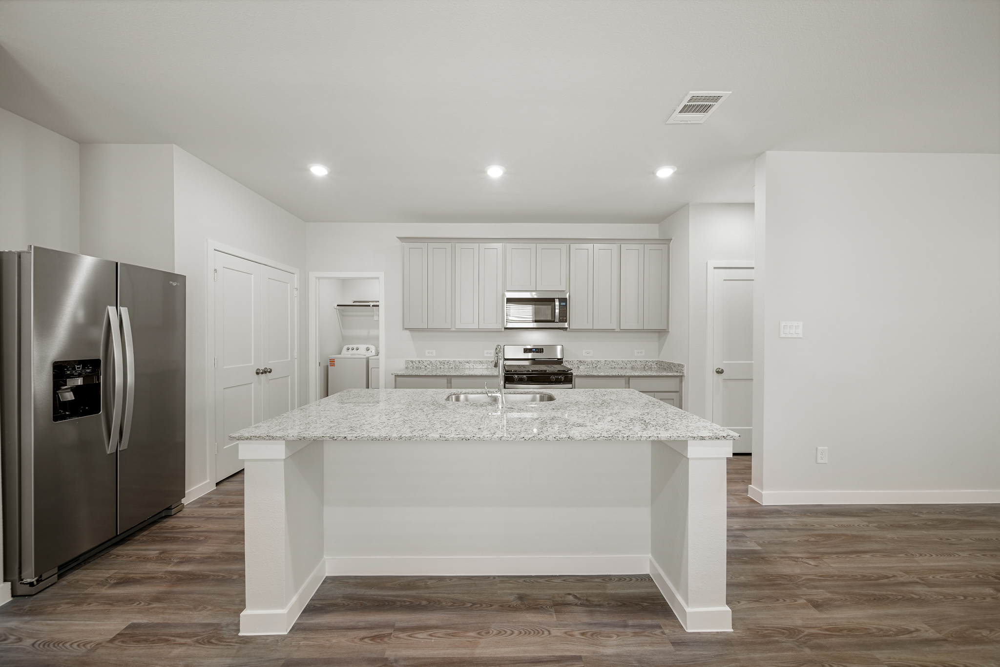 A kitchen with a marble counter.