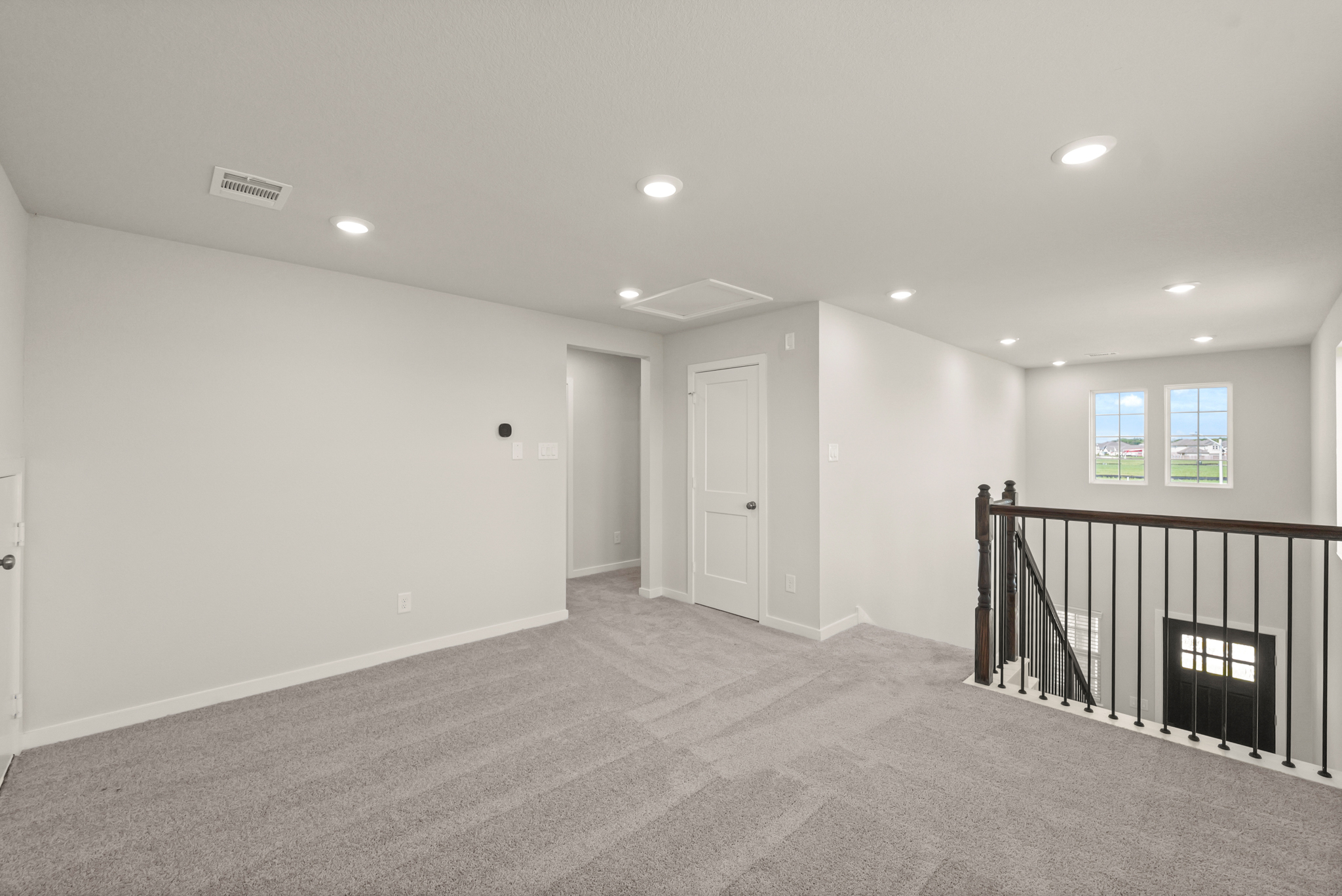 A room with a railing and a door.