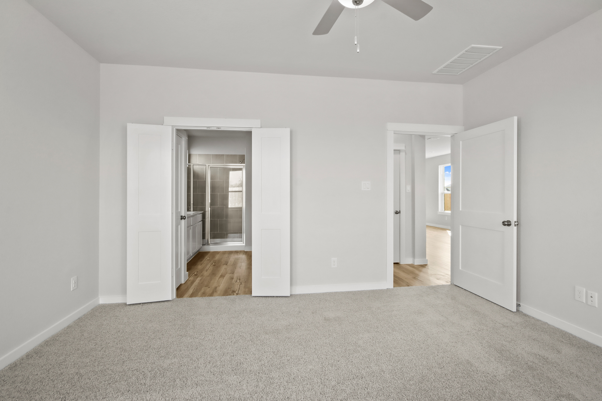 A room with white walls and a wood floor.