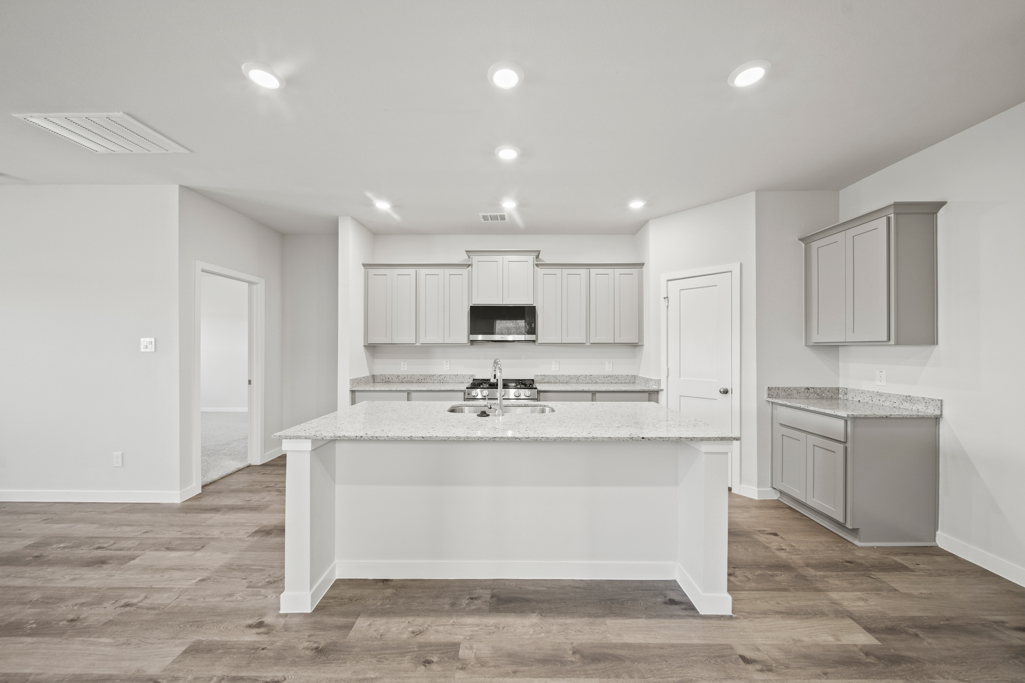 A kitchen with white cabinets.