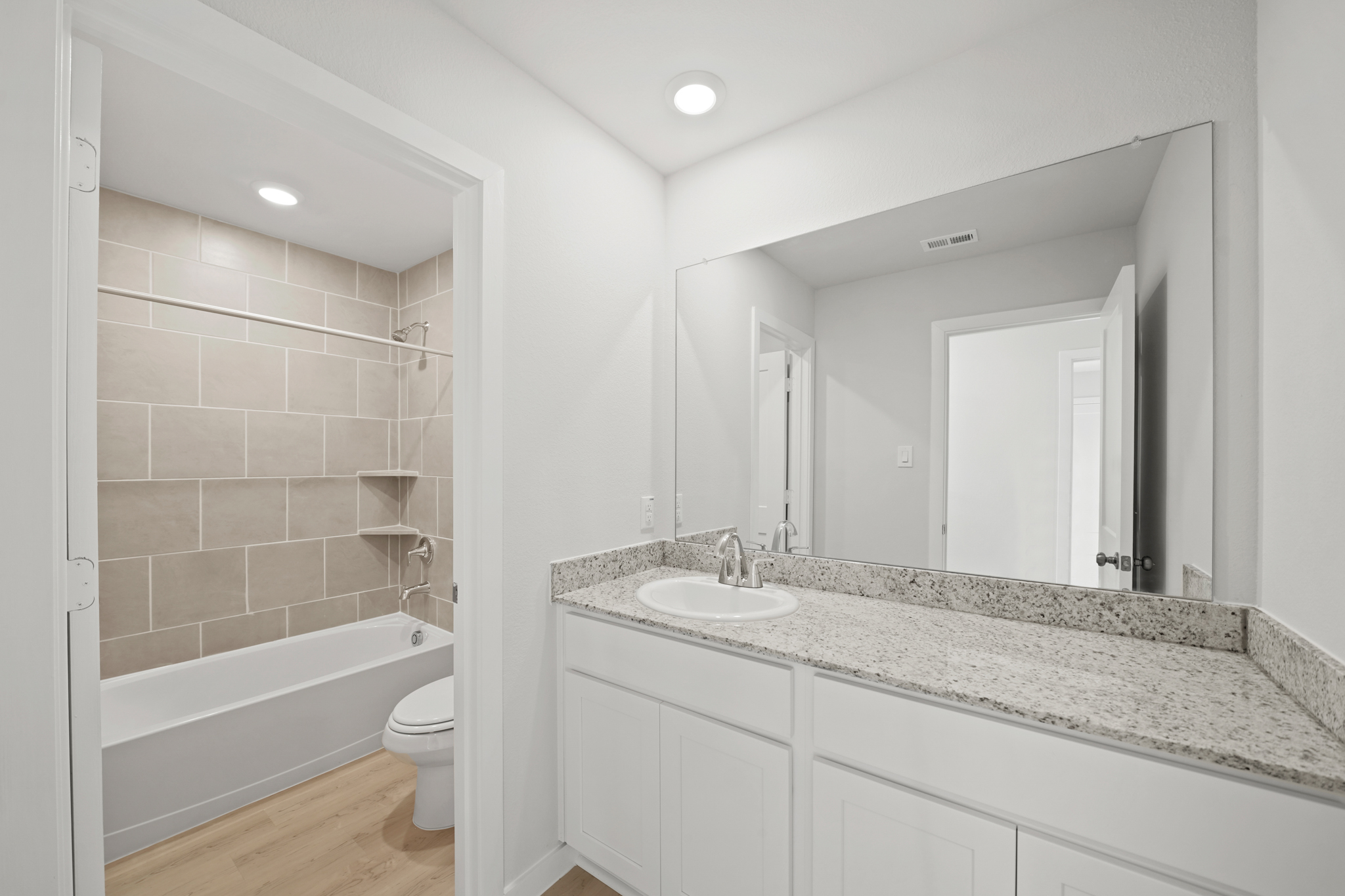 A bathroom with a marble countertop.