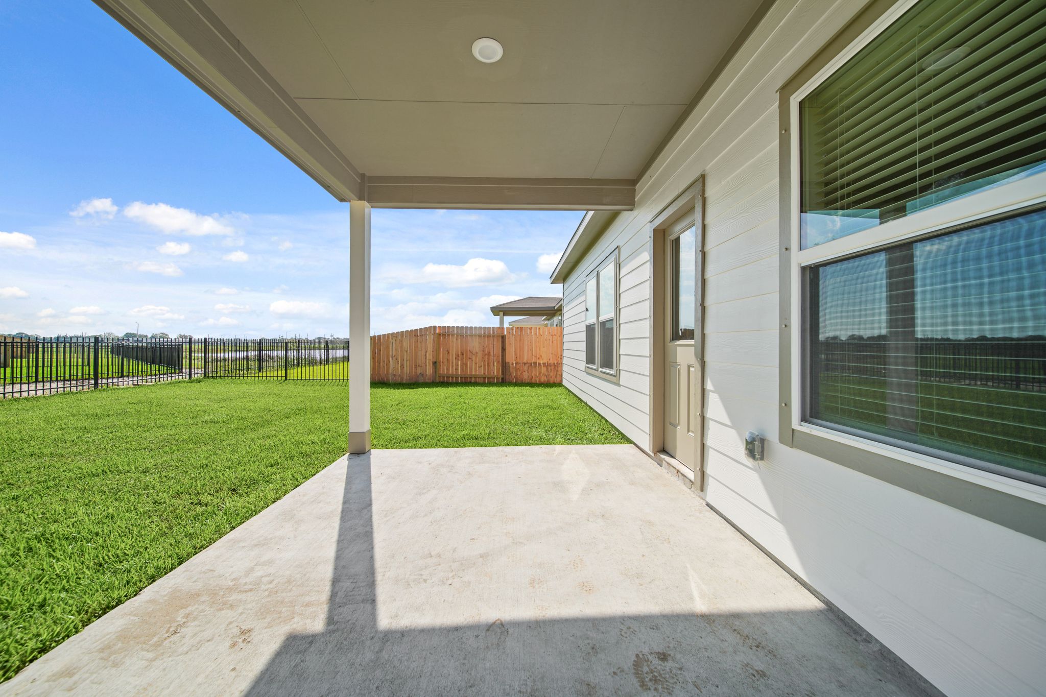 A house with a fence and grass.