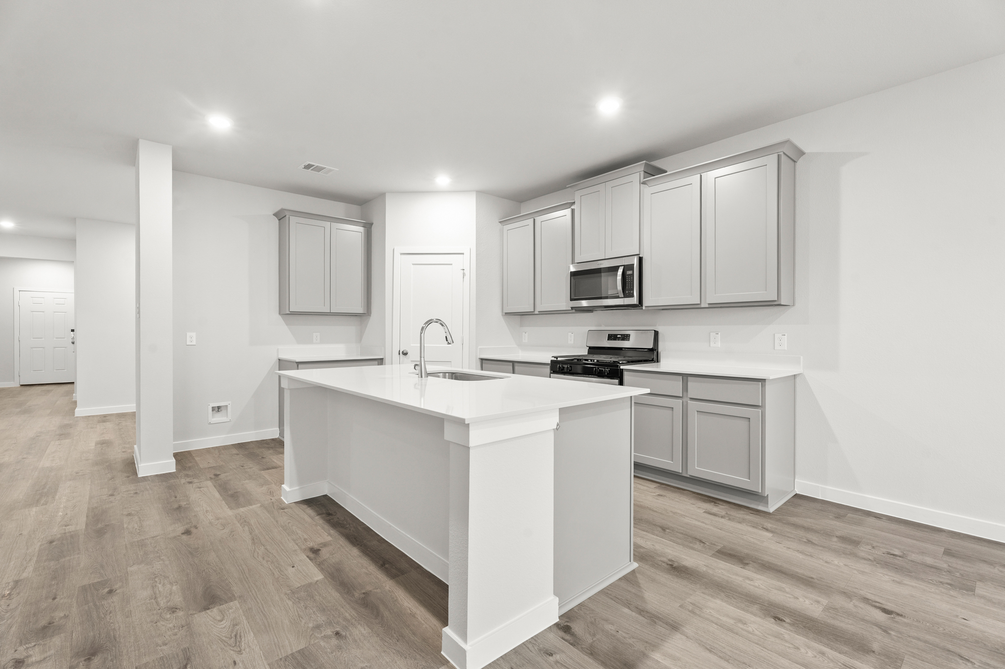 A kitchen with white cabinets.