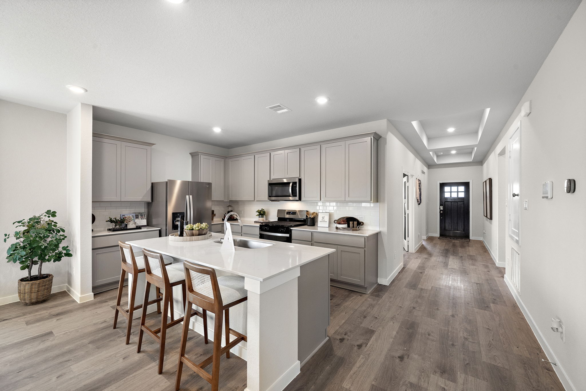 A kitchen with white cabinets.