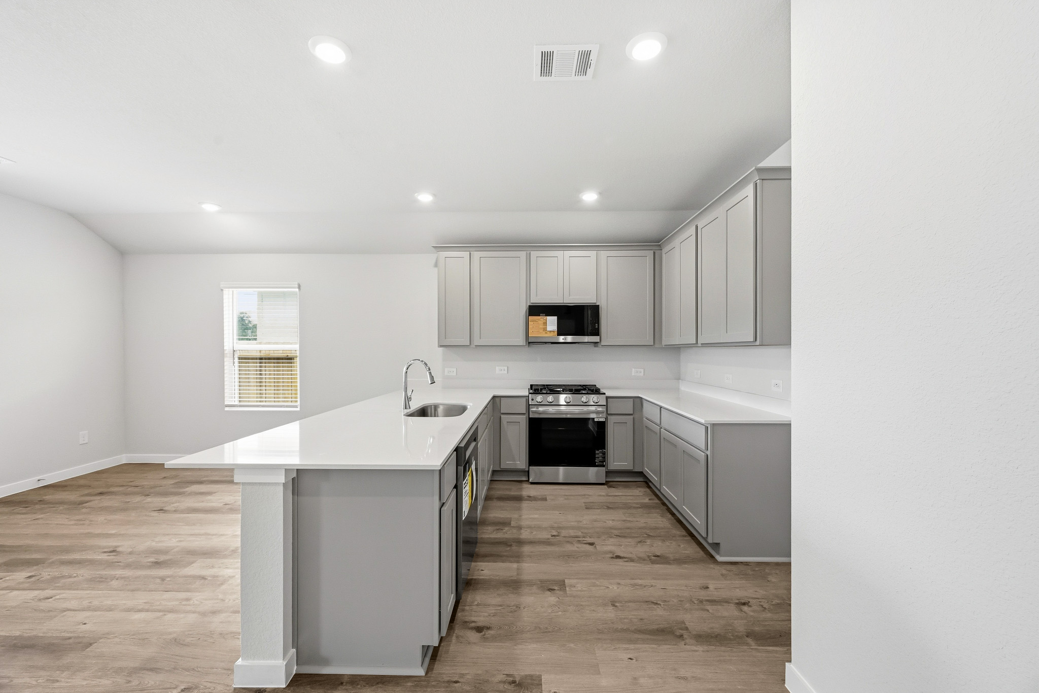 A kitchen with white cabinets.