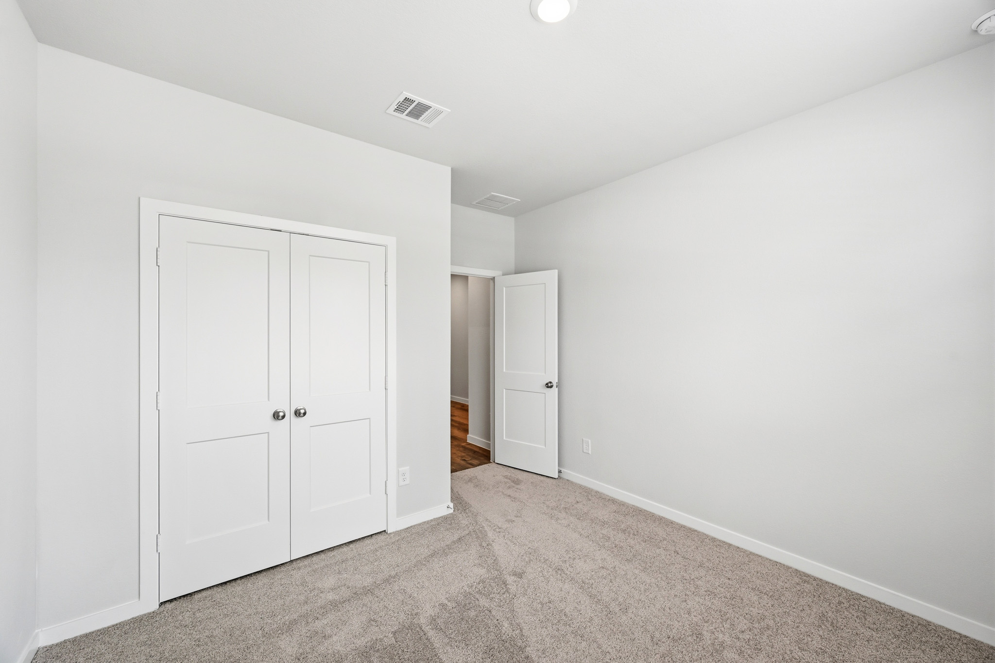 A hallway with white doors.