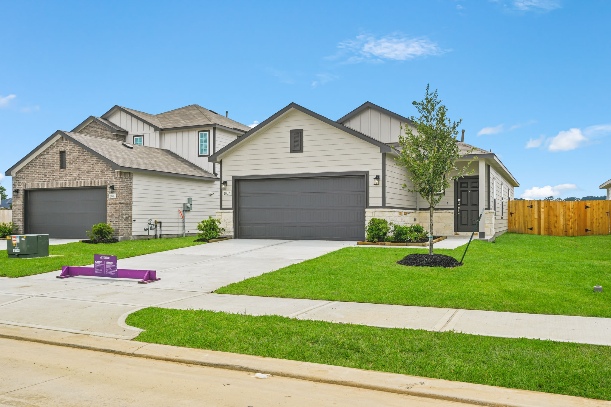 A house with a lawn and a tree in the front.