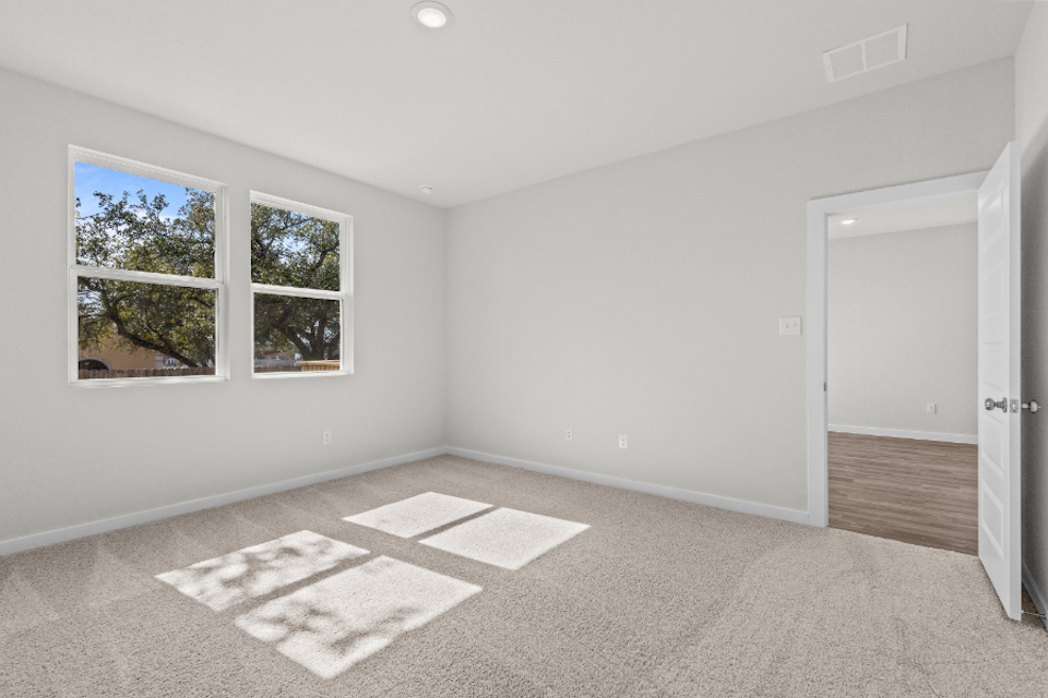 A room with a rug and a door.