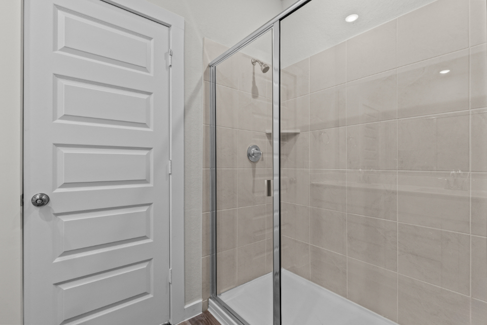 A shower with a glass door.