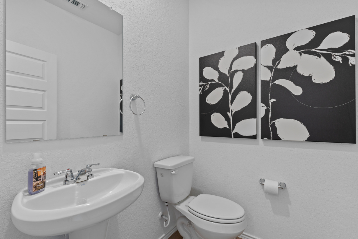 A bathroom with a toilet and a sink.