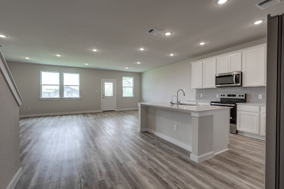 A kitchen with white cabinets.