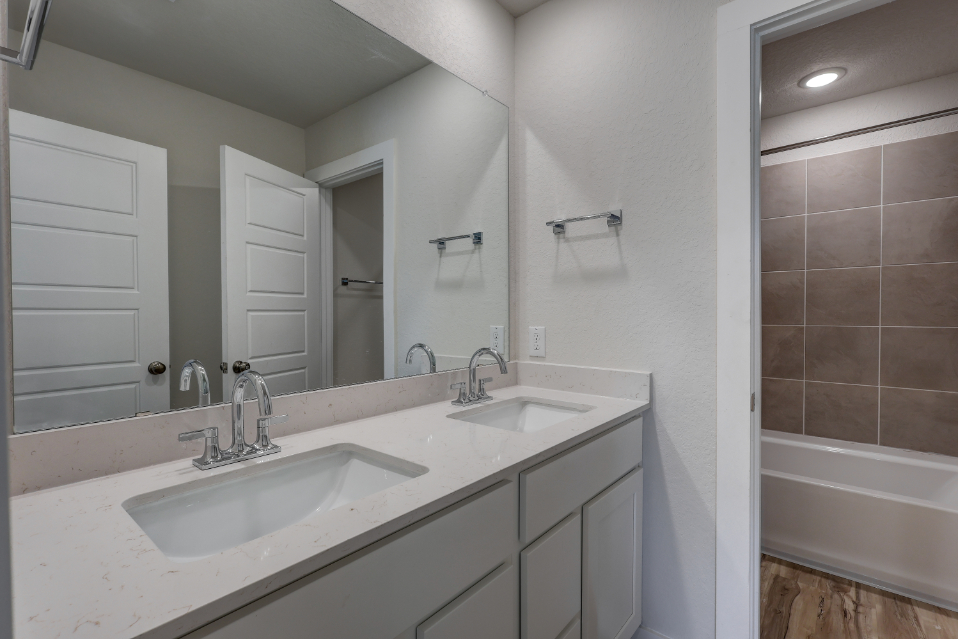 A bathroom with a sink and a tub.