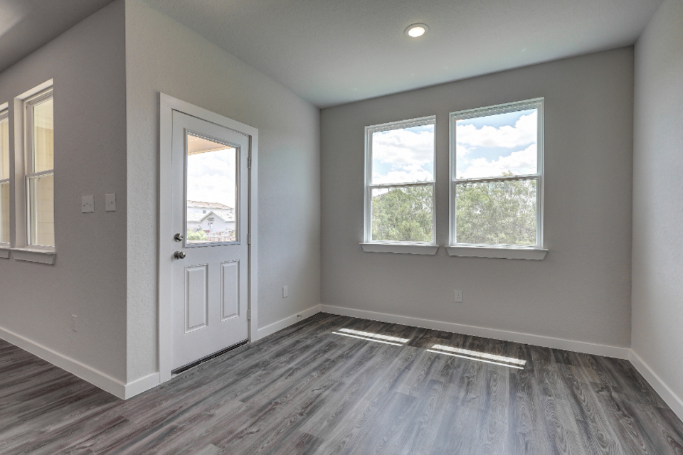 A room with a door and windows.