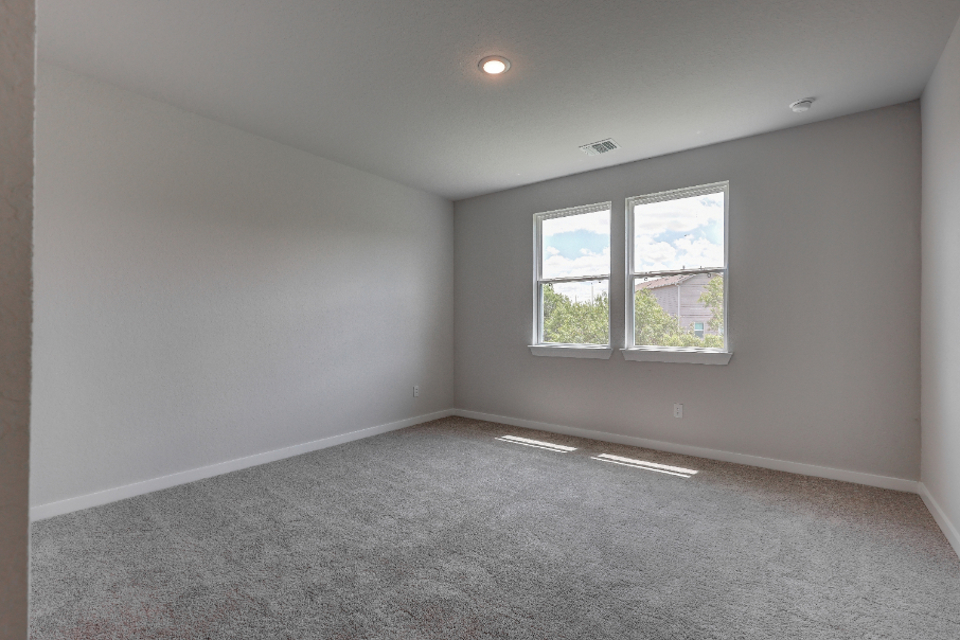 A room with windows and carpet.