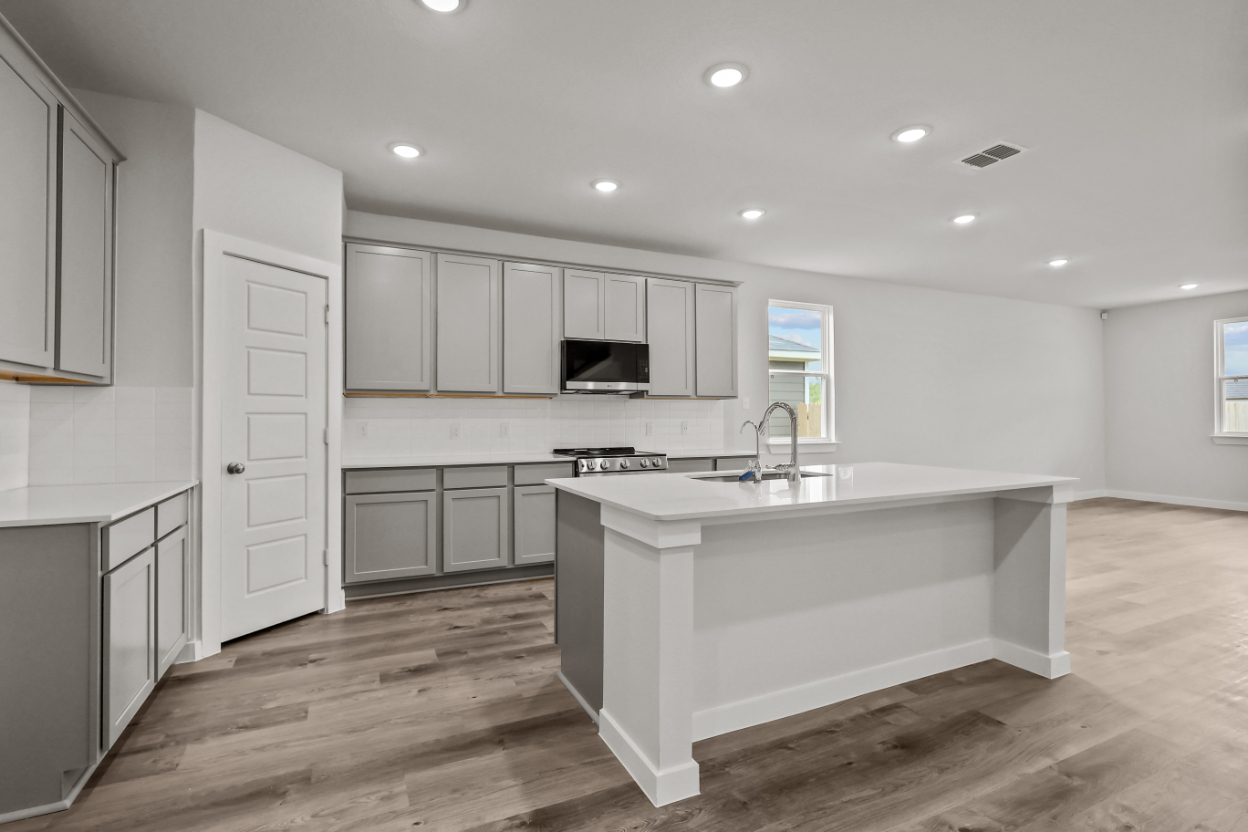 A kitchen with white cabinets.