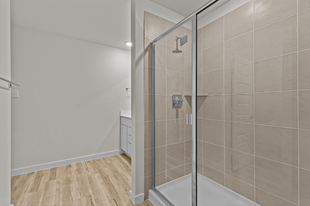 A shower with a glass door.