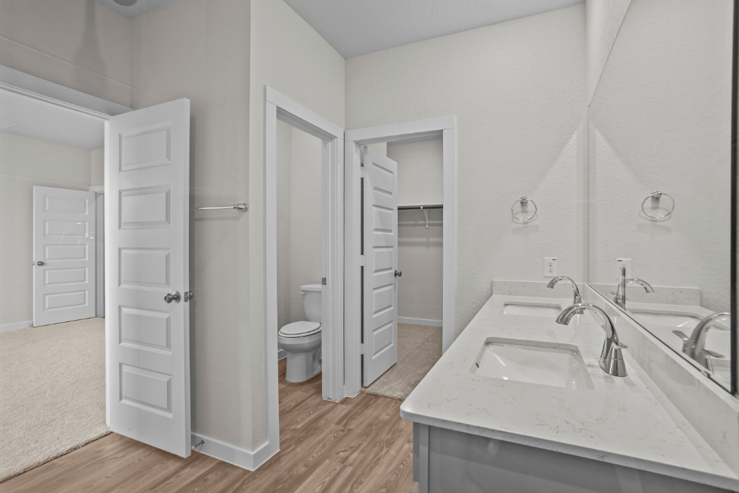 A bathroom with a sink toilet and a shower.