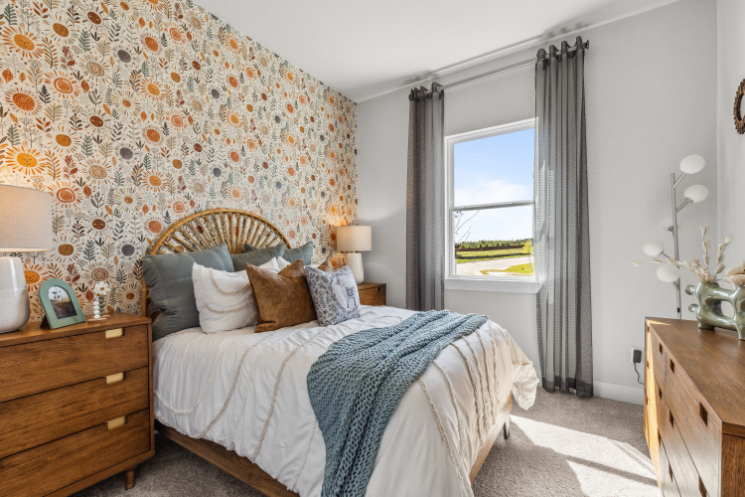 A bedroom with a bed and a window.
