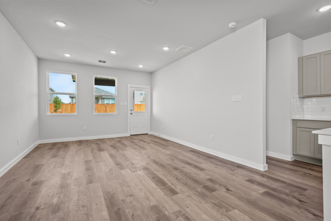 A room with a wood floor and white walls.