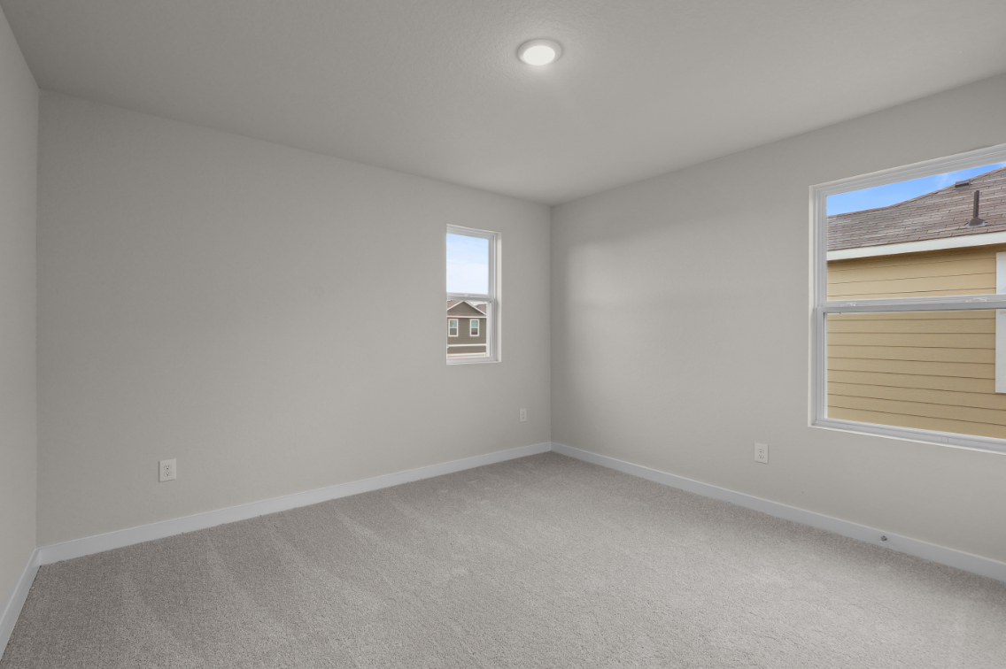 A room with a window and a carpet.