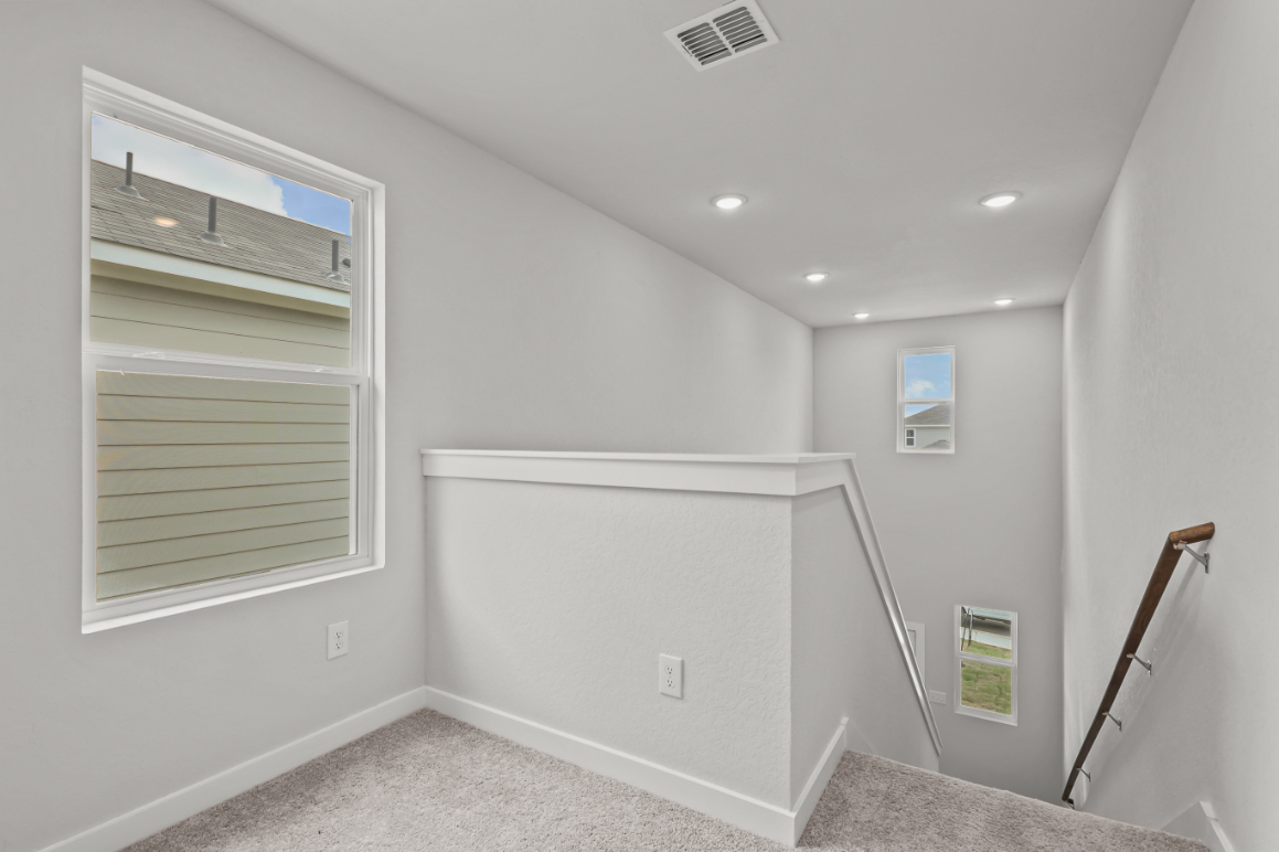 A white room with a shower and a ladder.