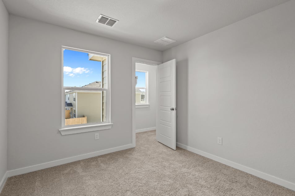 A room with a mirror and a door.