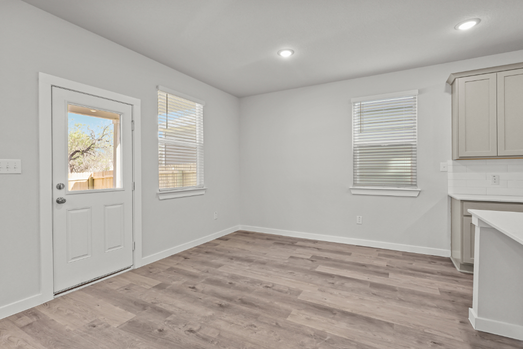 A room with white walls and a wood floor.