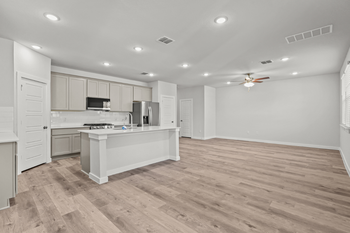 A kitchen with white cabinets.