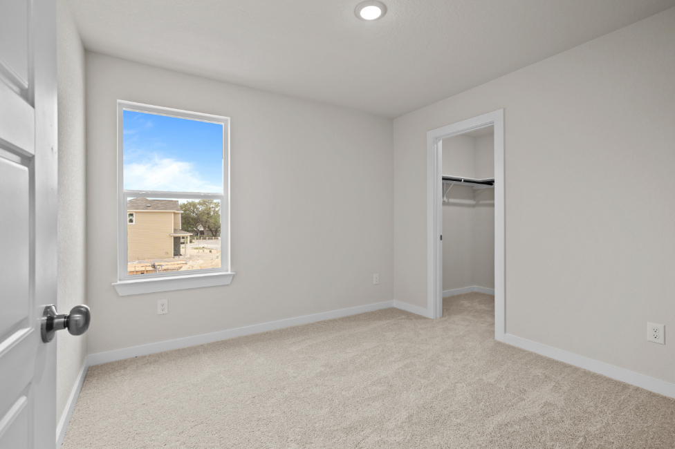 A room with a window and a door.