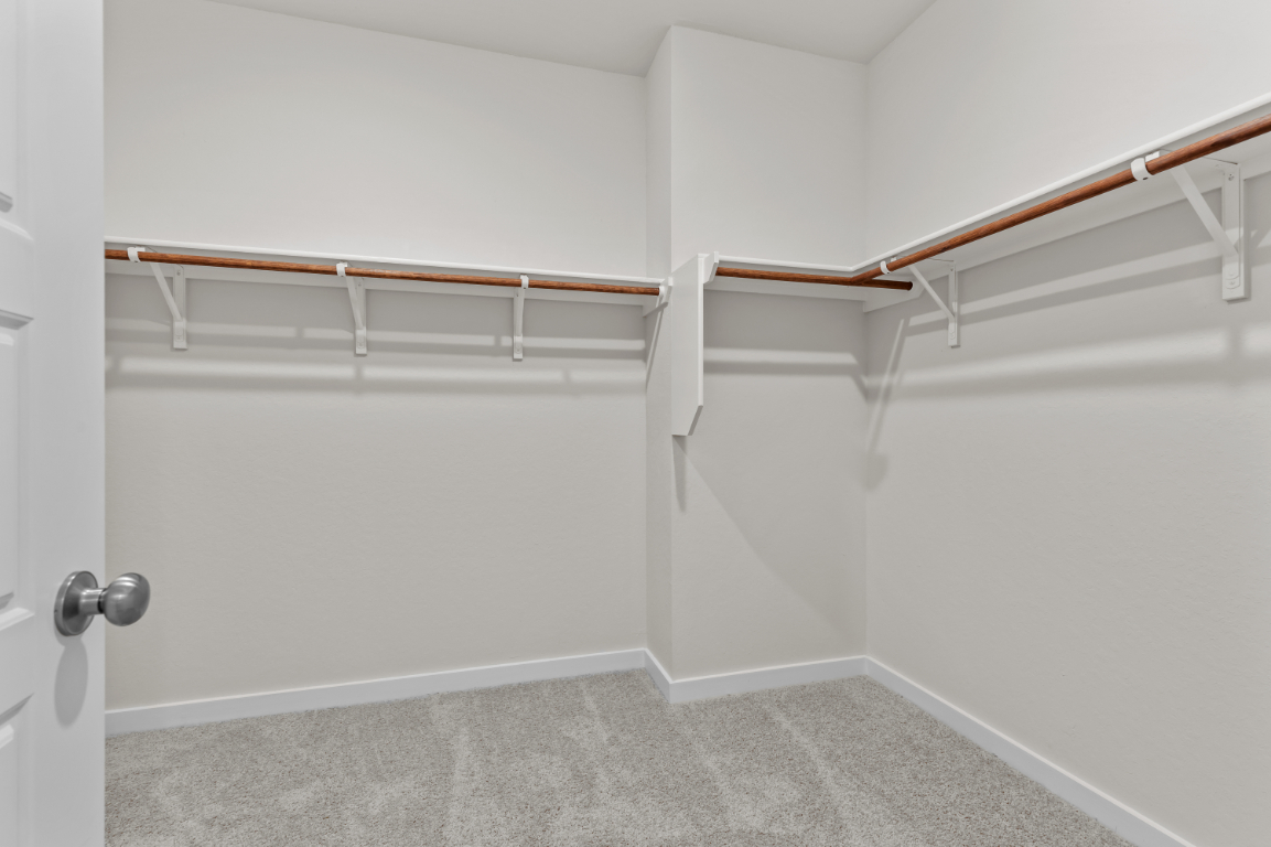 A white room with a white wall and a metal railing.