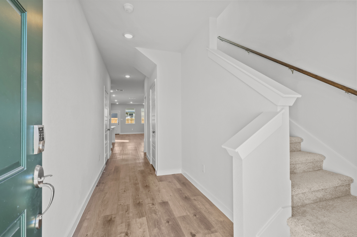 A hallway with white walls.