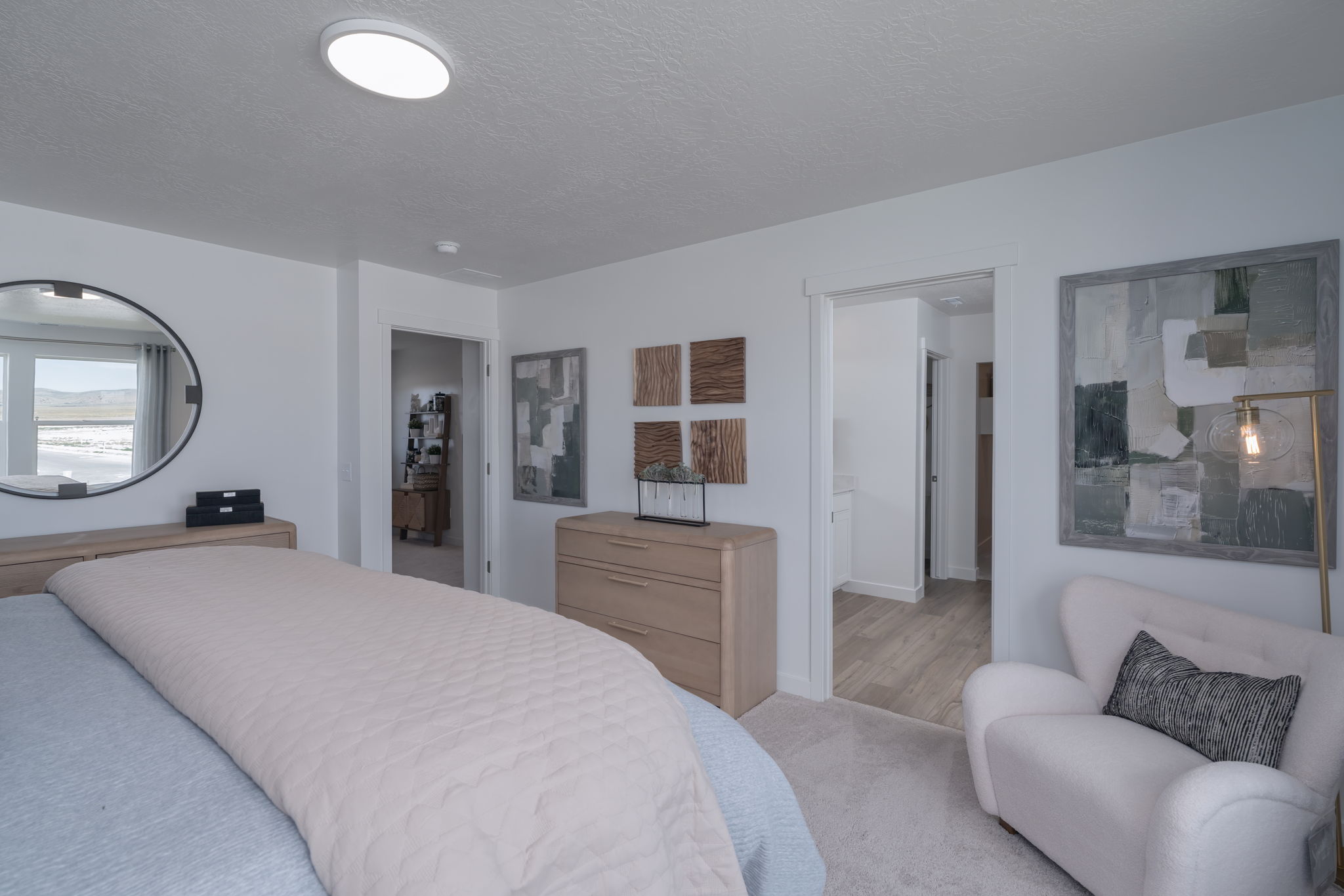 A bedroom with a bed and a chair.