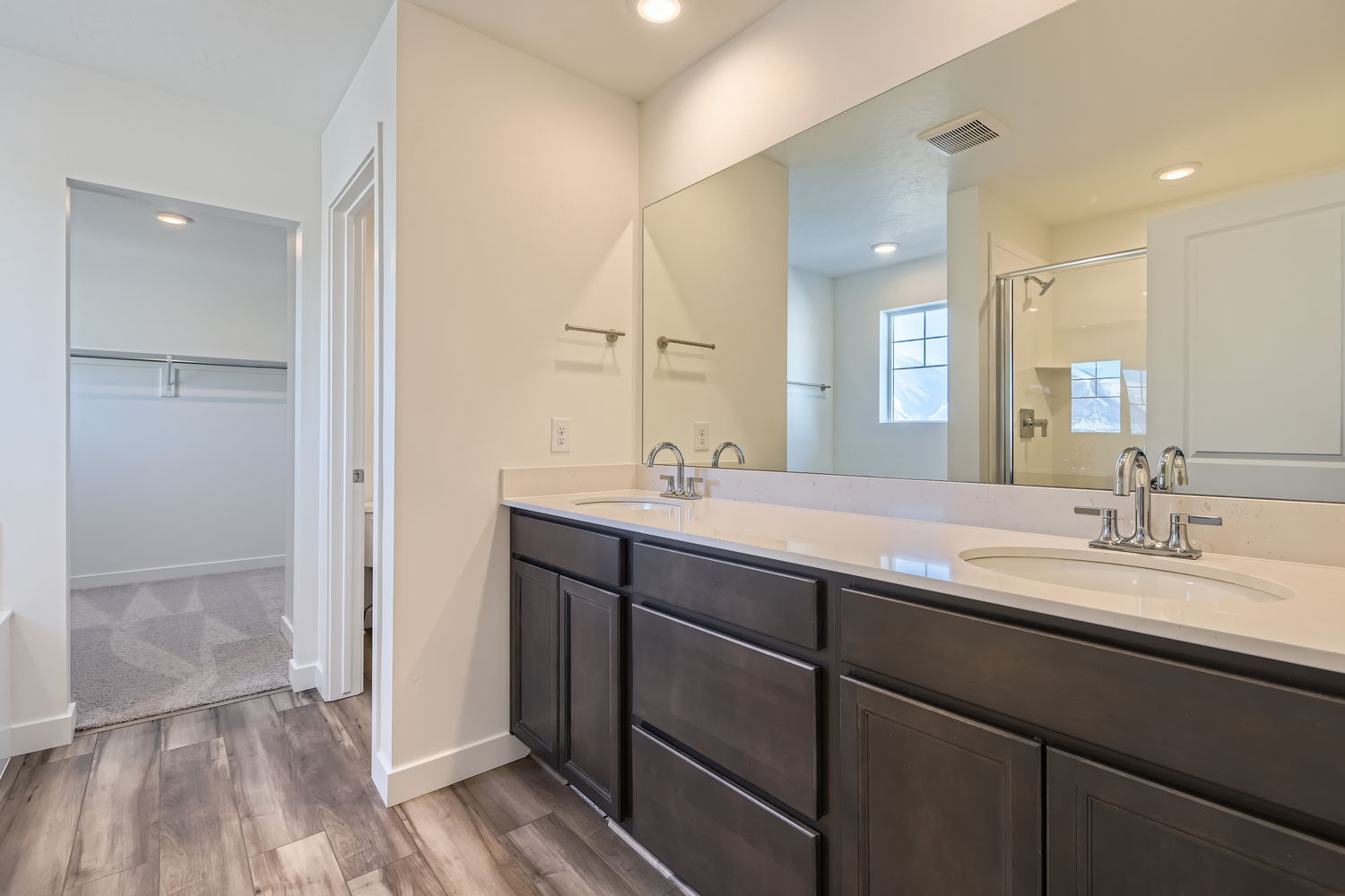 A bathroom with a large mirror.