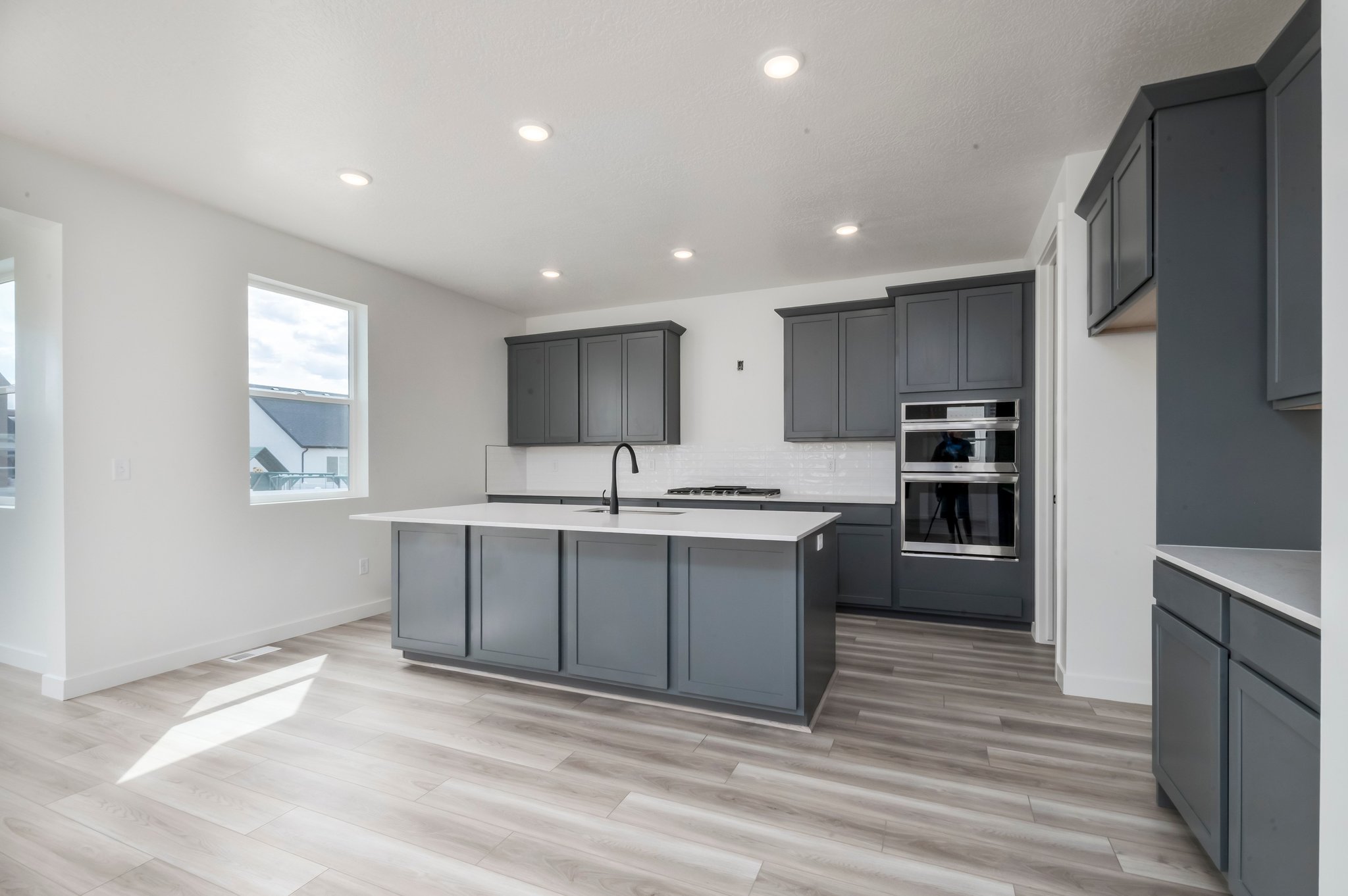 A kitchen with black cabinets.
