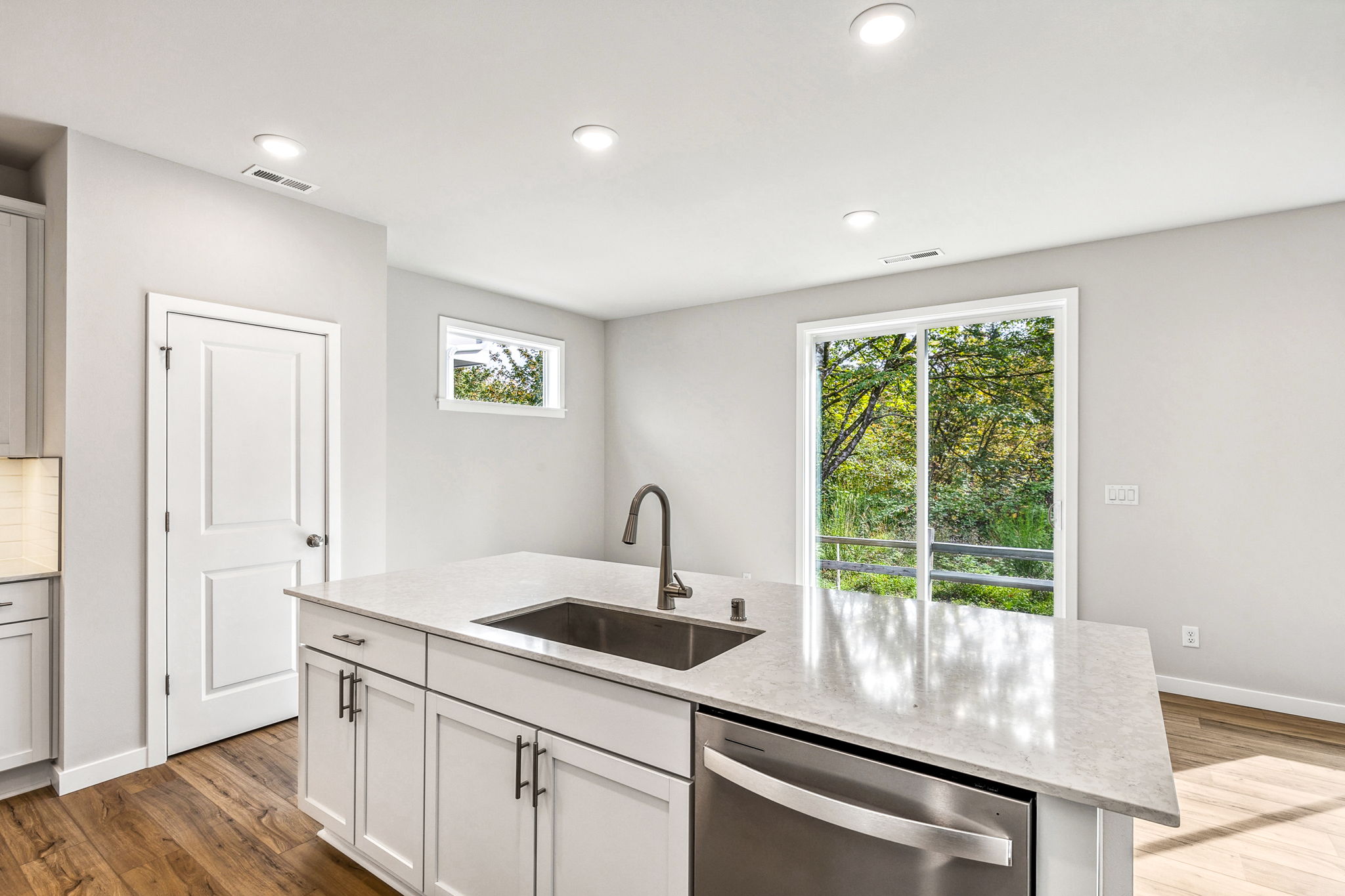 A kitchen with a marble countertop.