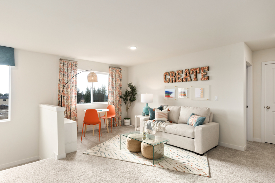 A living room with a couch and a rug.