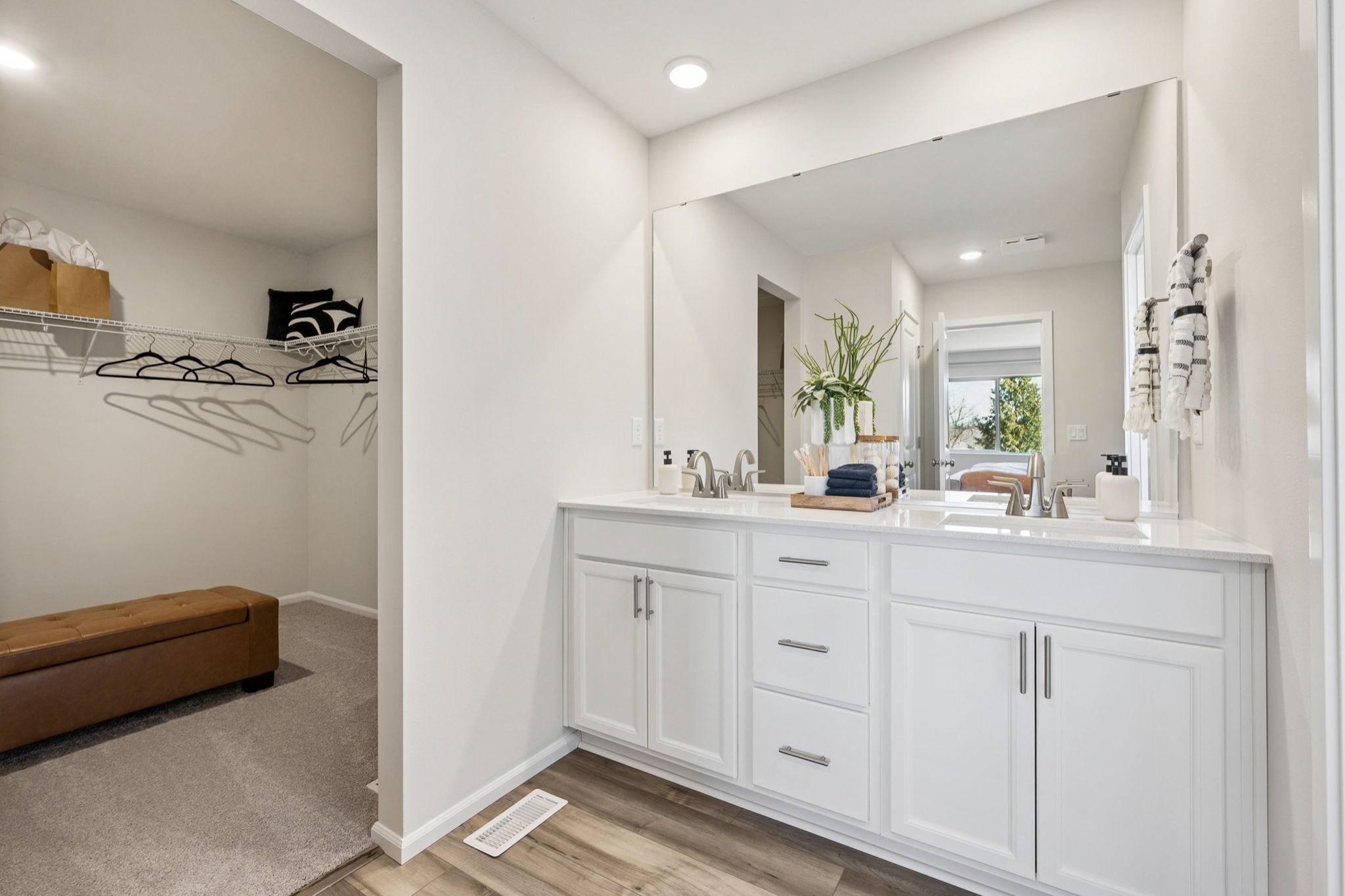 A bathroom with white cabinets.