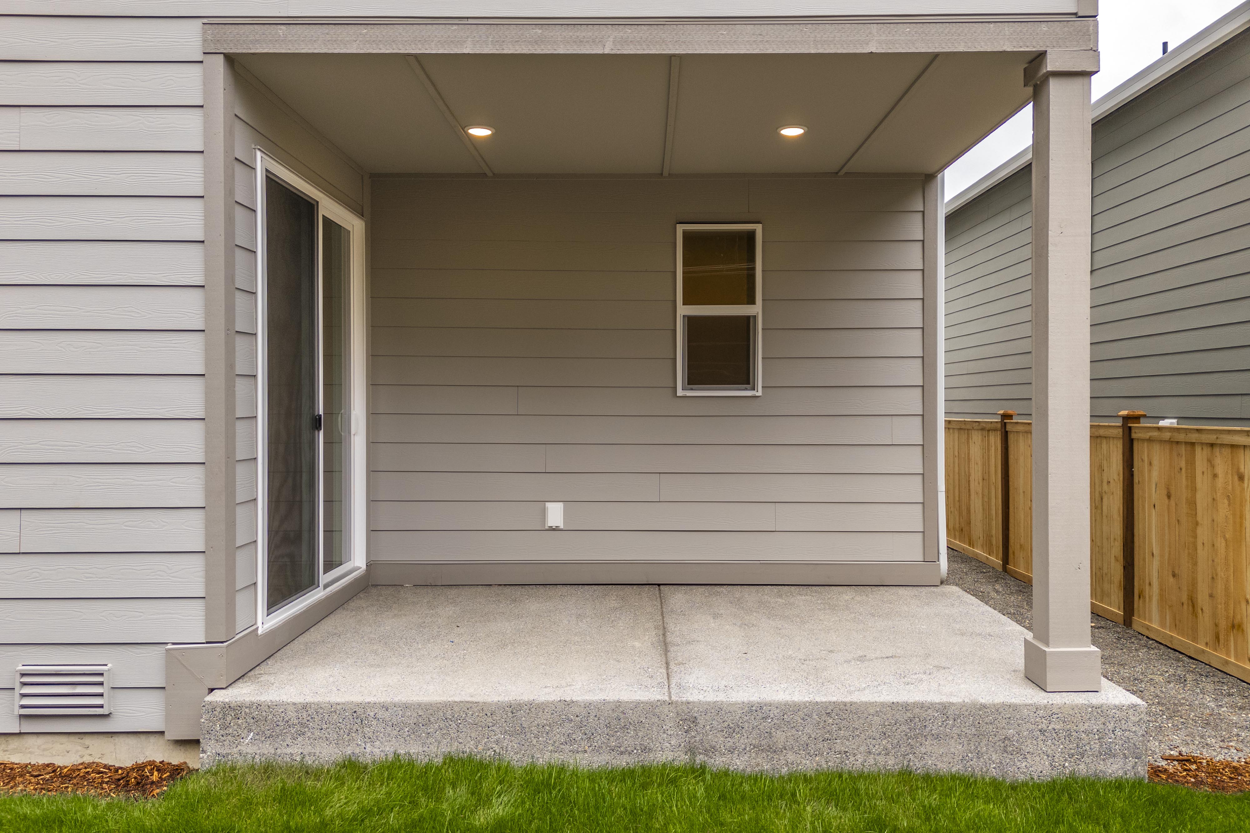 A grey house with a garage.