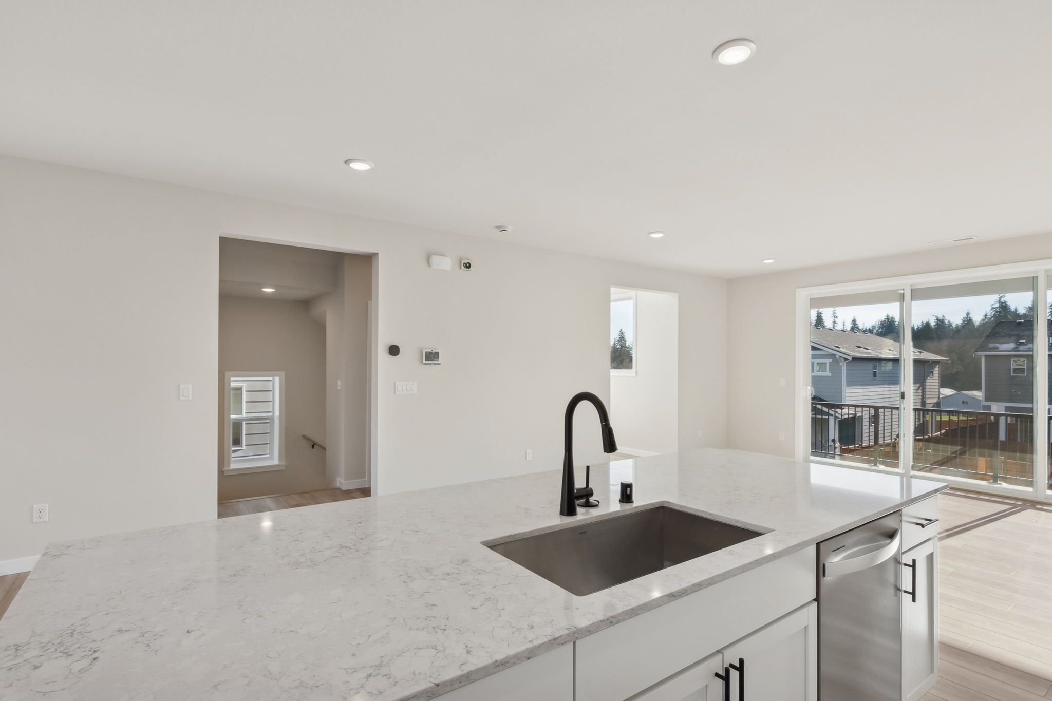 A kitchen with a sink and a large window.