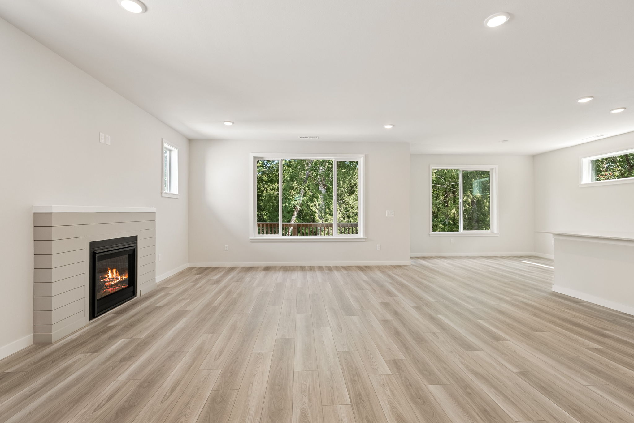 A room with a fireplace and a wood floor.