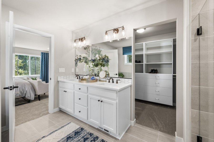A bathroom with a sink and a bed.
