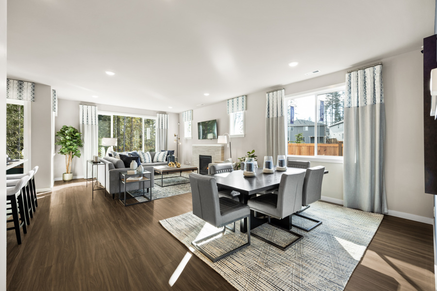 A large living room with a large dining table and chairs.