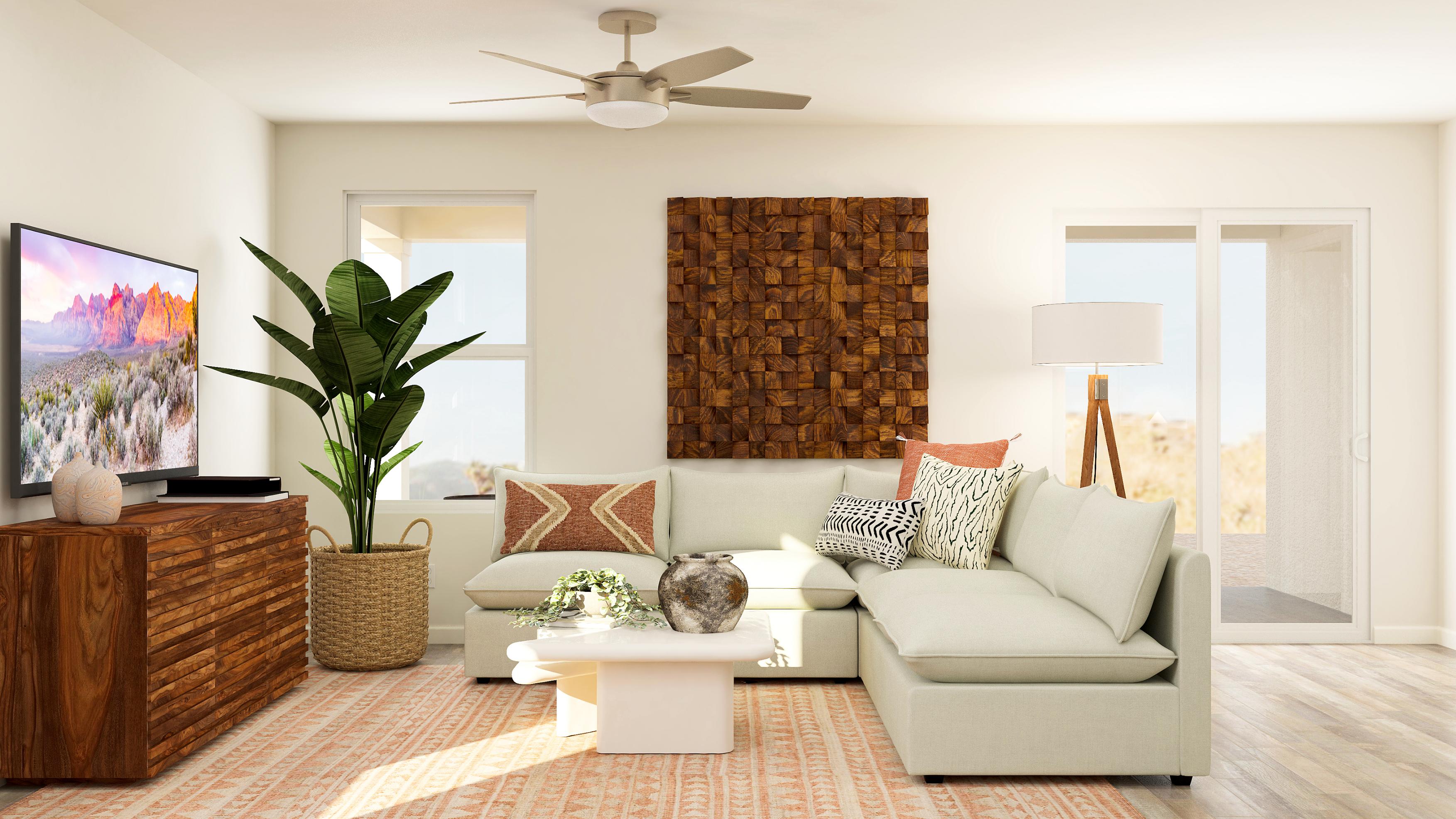 A living room with a white couch and a fan.