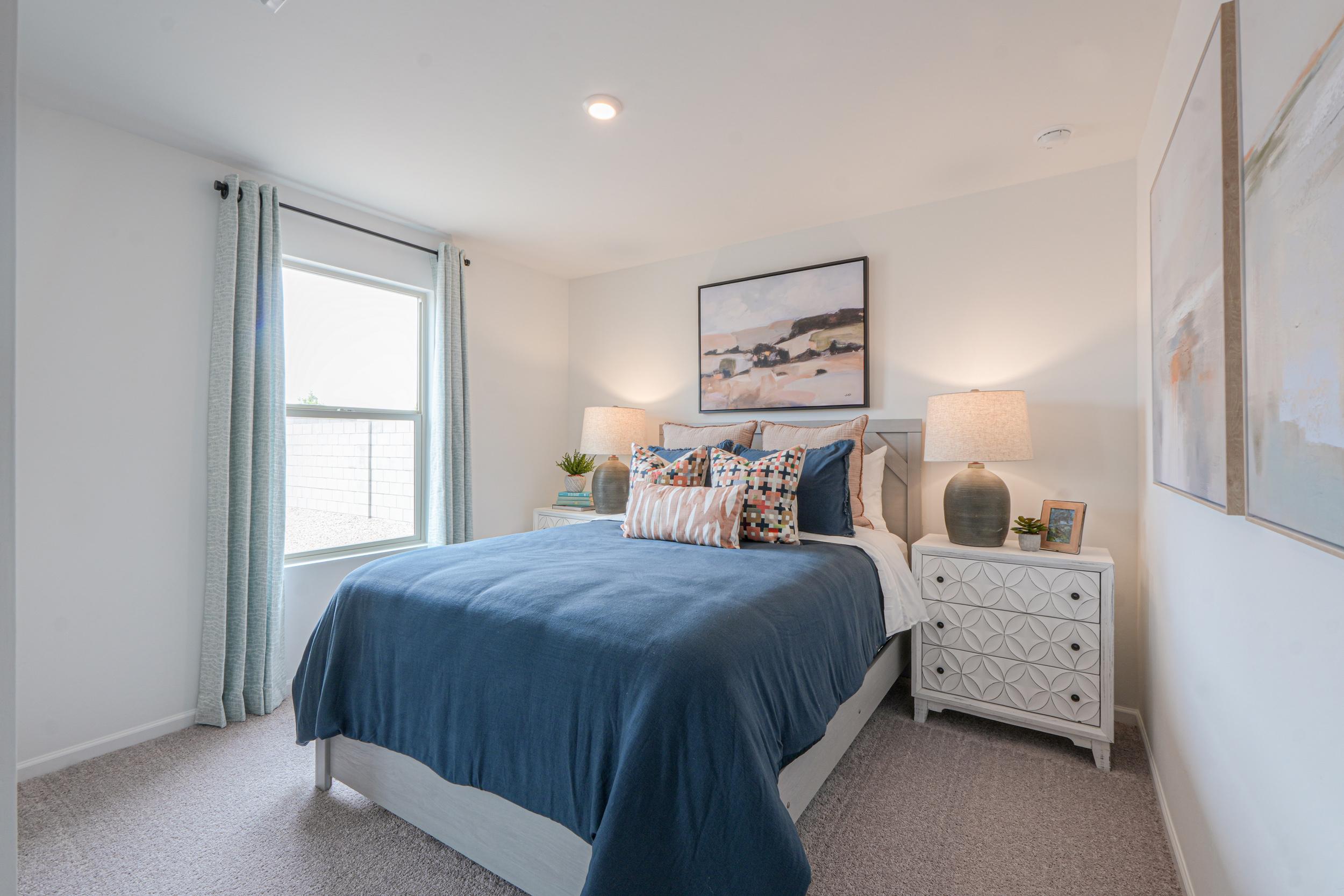 A bedroom with a bed and a dresser.
